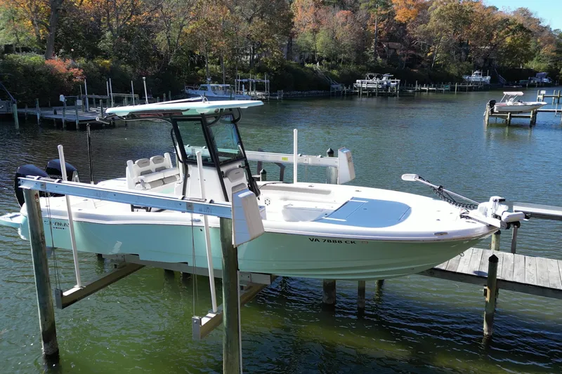  Yacht Photos Pics 2023 Caymas 281 HB boat docked on a serene lake with autumn foliage.