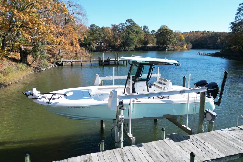  Yacht Photos Pics 2023 Caymas 281 HB boat docked on a serene lake with autumn foliage.