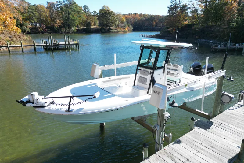  Yacht Photos Pics 2023 Caymas 281 HB boat docked on a serene lake with autumn foliage.