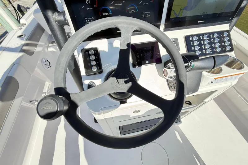  Yacht Photos Pics Steering wheel and dashboard of 2023 Caymas 281 HB boat, featuring modern controls.