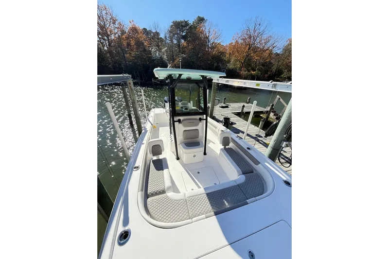  Yacht Photos Pics 2023 Caymas 281 HB boat docked by a scenic lakeside.