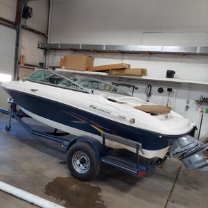 2007 Four Winns Horizon boat on trailer in garage setting.