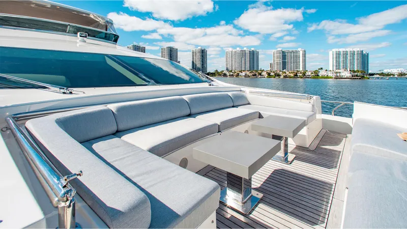 Bt2 Yacht Photos Pics Luxurious 2010 Azimut 95 yacht deck with seating, tables, and waterfront cityscape.