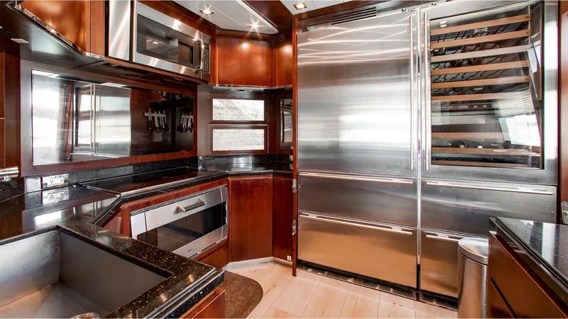 Bt2 Yacht Photos Pics Luxurious kitchen interior of 2010 Azimut 95 yacht with stainless steel appliances.