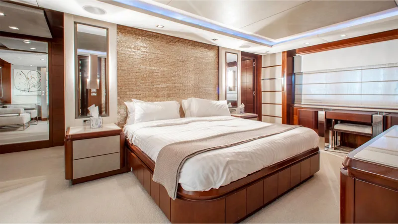 Bt2 Yacht Photos Pics Luxurious bedroom interior on 2010 Azimut 95 yacht, featuring elegant wood finishes and modern design.