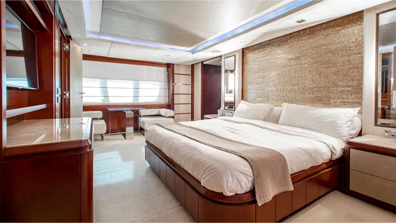 Bt2 Yacht Photos Pics Luxurious bedroom interior of 2010 Azimut 95 yacht with elegant furnishings and ambient lighting.