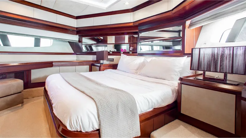 Bt2 Yacht Photos Pics Luxurious bedroom interior of 2010 Azimut 95 yacht with elegant wood finishes and modern decor.