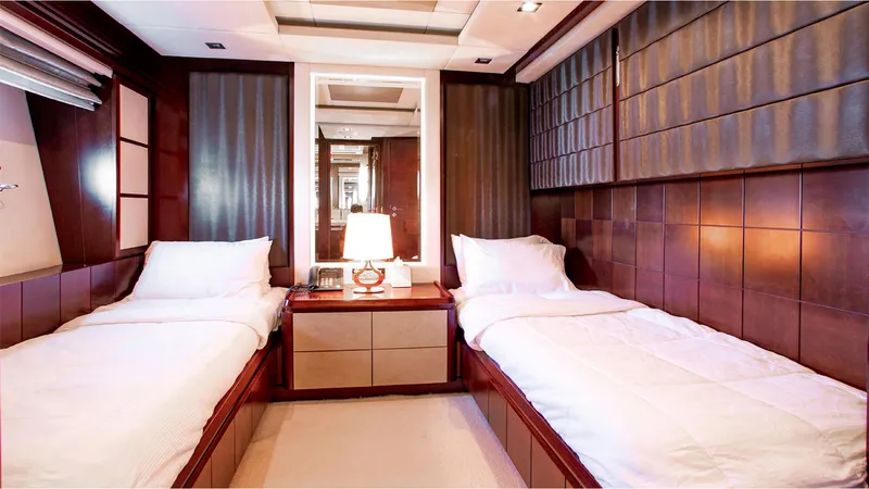 Bt2 Yacht Photos Pics Luxurious twin bedroom on 2010 Azimut 95 yacht with elegant wood paneling.