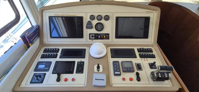 Getaway Yacht Photos Pics Control panel of a 2012 Gianetti Navetta 67 yacht with navigation screens and instruments.
