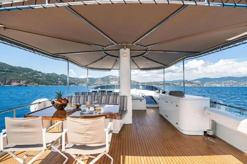 Getaway Yacht Photos Pics Luxurious Gianetti Navetta 67 yacht deck with dining area, ocean view, and canopy, 2012 model.
