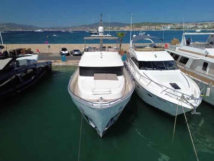 Getaway Yacht Photos Pics Gianetti Navetta 67 yacht docked at marina, 2012 model, with scenic coastal backdrop.