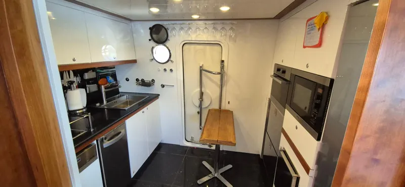 Getaway Yacht Photos Pics Modern kitchen interior on 2012 Gianetti Navetta 67 yacht, featuring sleek appliances and compact design.