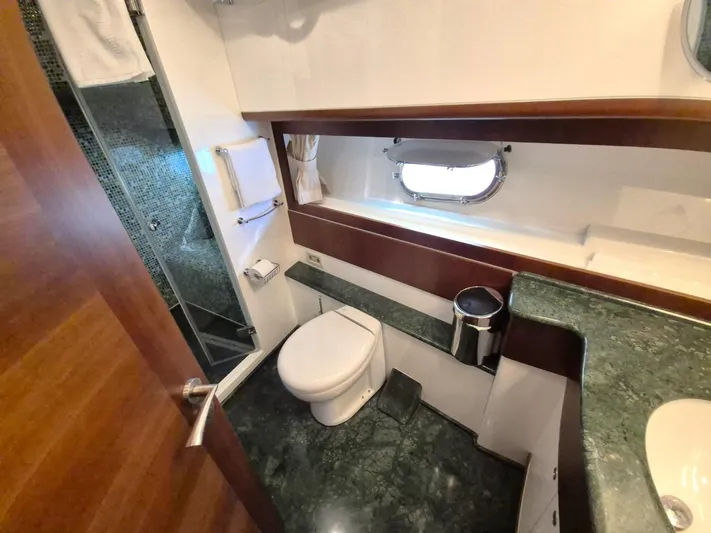 Getaway Yacht Photos Pics Luxurious bathroom in 2012 Gianetti Navetta 67 yacht with modern fixtures and green marble accents.