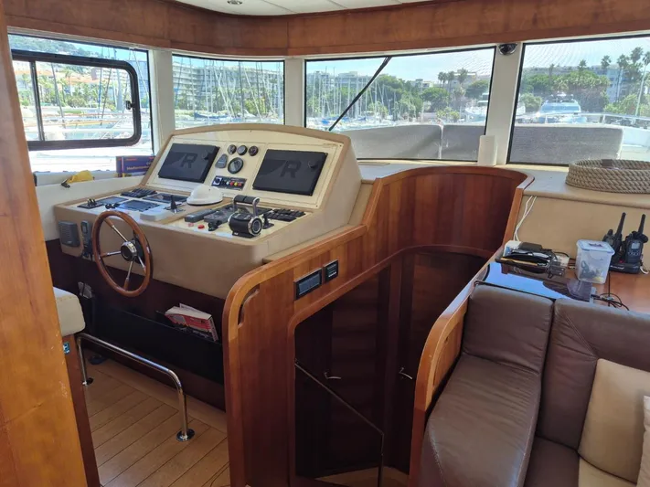 Getaway Yacht Photos Pics Interior helm of 2012 Gianetti Navetta 67 yacht with wooden accents and navigation equipment.