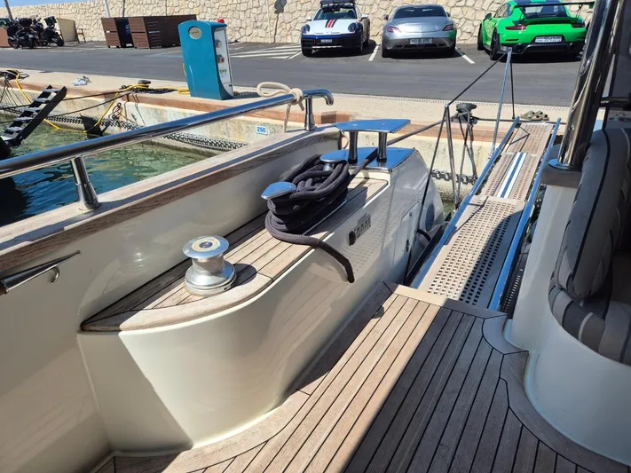 Getaway Yacht Photos Pics Gianetti Navetta 67 yacht docked, featuring wooden deck and mooring equipment, 2012 model.
