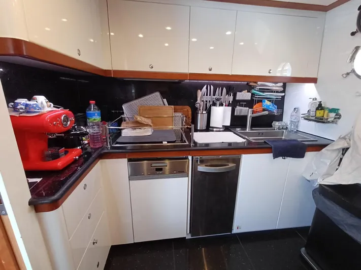 Getaway Yacht Photos Pics Modern kitchen in a 2012 Gianetti Navetta 67 yacht with red espresso machine.