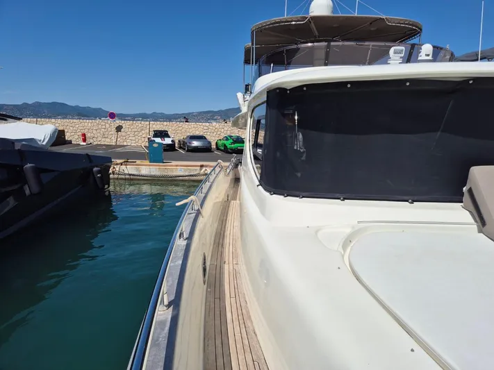 Getaway Yacht Photos Pics Gianetti Navetta 67 yacht docked at marina, 2012 model, with clear blue sky.