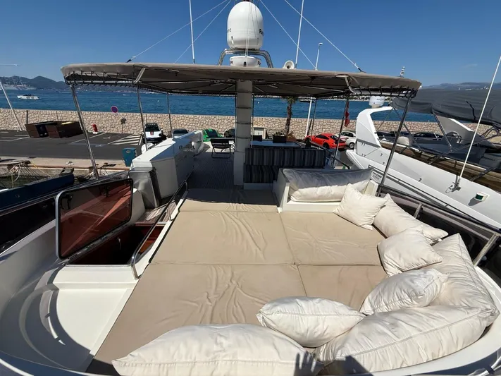 Getaway Yacht Photos Pics Luxurious Gianetti Navetta 67 yacht deck with sunbathing area, cushions, and ocean view.