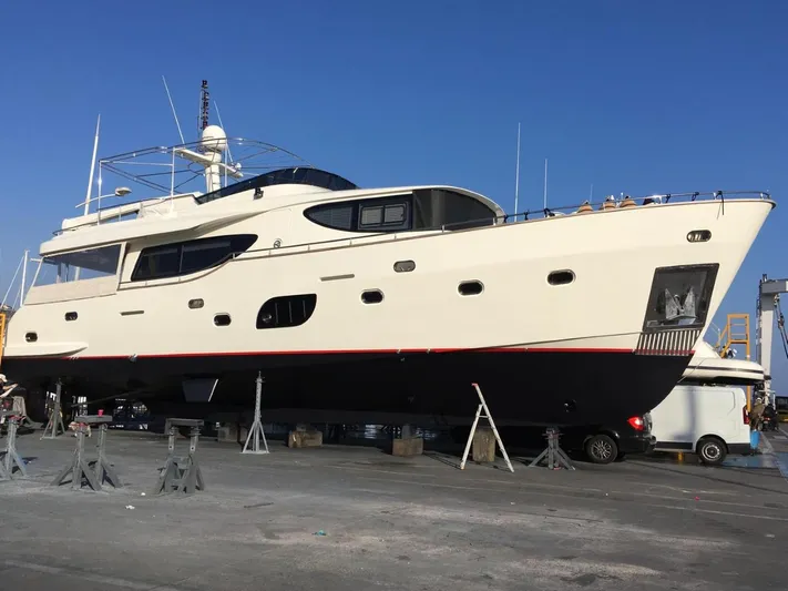 Getaway Yacht Photos Pics Gianetti Navetta 67 yacht from 2012 on dry dock under clear blue sky.