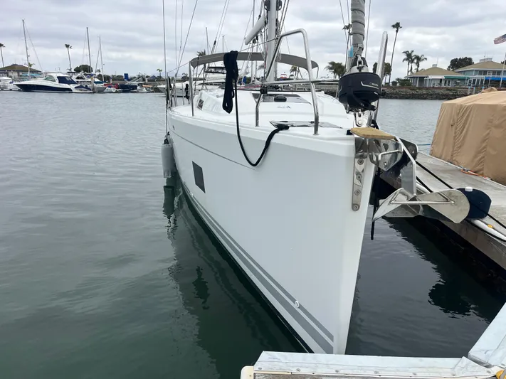 Silver Alert Yacht Photos Pics 2021 Hanse 418 sailboat docked in a marina, overcast sky, calm water.