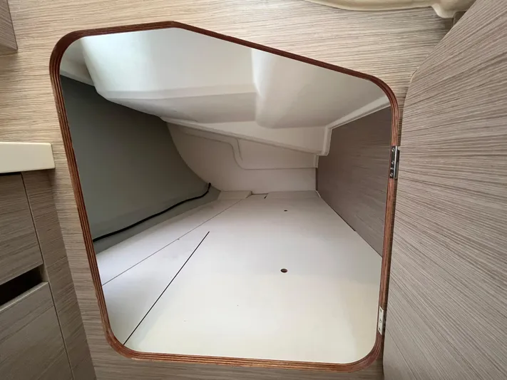 Silver Alert Yacht Photos Pics Interior storage compartment of a 2021 Hanse 418 yacht, featuring sleek wooden finish.
