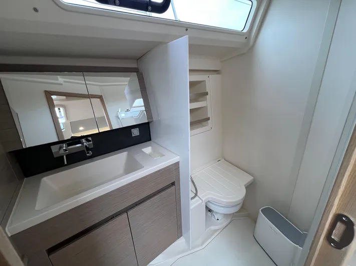 Silver Alert Yacht Photos Pics Modern bathroom in 2021 Hanse 418 yacht with sink, mirror, and toilet.