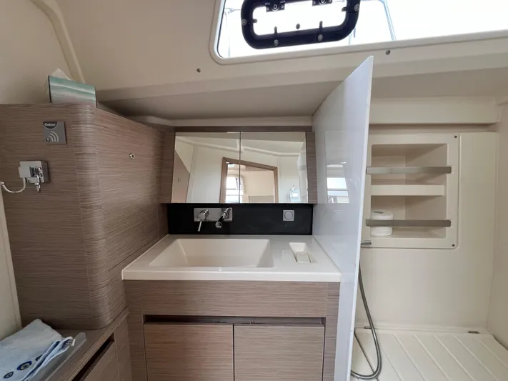 Silver Alert Yacht Photos Pics Modern bathroom interior of 2021 Hanse 418 yacht with sink and storage.