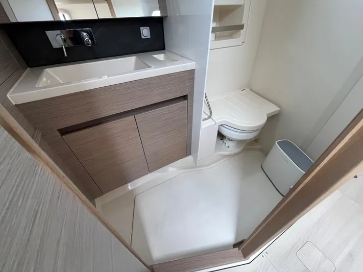 Silver Alert Yacht Photos Pics Modern bathroom in 2021 Hanse 418 yacht with sink, toilet, and storage.