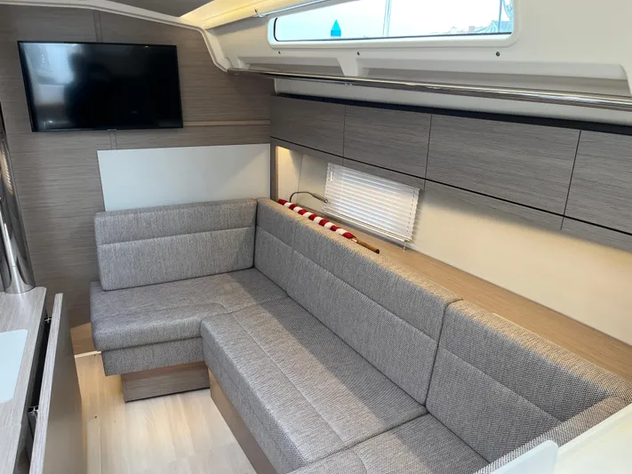 Silver Alert Yacht Photos Pics Modern interior of 2021 Hanse 418 yacht with cozy seating and wall-mounted TV.