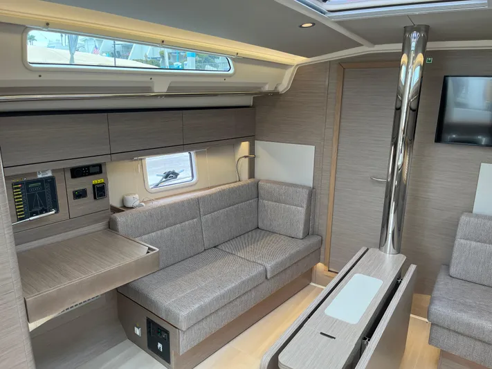 Silver Alert Yacht Photos Pics Modern interior of 2021 Hanse 418 yacht with cozy seating and sleek design.
