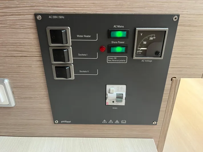 Silver Alert Yacht Photos Pics Control panel of a 2021 Hanse 418 yacht, featuring switches and voltage meter.