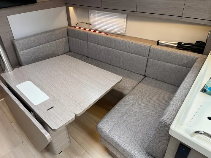 Silver Alert Yacht Photos Pics Modern interior of 2021 Hanse 418 yacht with cozy seating and dining area.