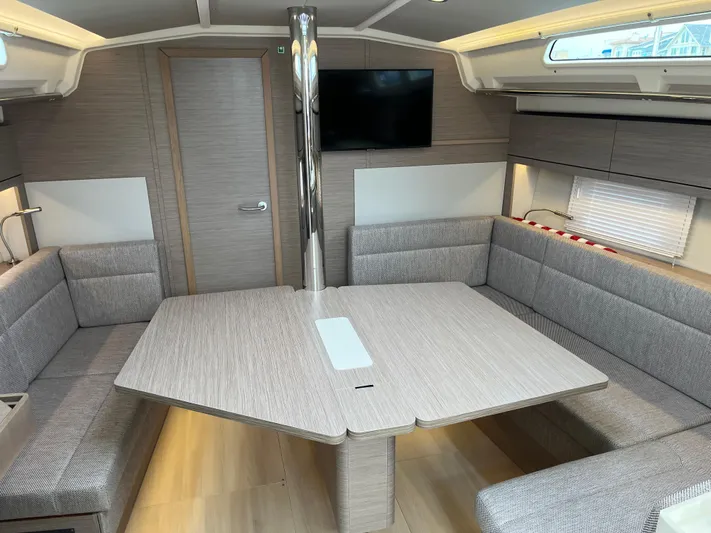 Silver Alert Yacht Photos Pics Modern interior of 2021 Hanse 418 yacht with dining area and TV.