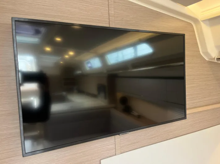 Silver Alert Yacht Photos Pics Flat-screen TV inside 2021 Hanse 418 yacht, reflecting interior cabin details.