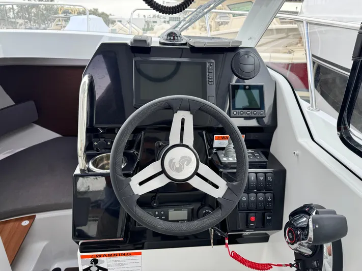  Yacht Photos Pics 2025 Beneteau Antares 8 helm with modern controls and navigation system.