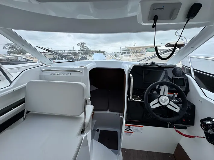  Yacht Photos Pics Interior view of 2025 Beneteau Antares 8 boat cockpit with steering wheel and seating.
