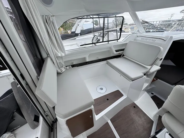  Yacht Photos Pics 2025 Beneteau Antares 8 interior seating area with modern design and large windows.