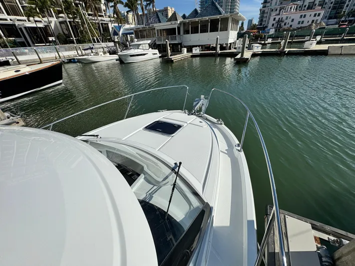  Yacht Photos Pics 2025 Beneteau Antares 8 docked in a marina, showcasing sleek design and modern features.