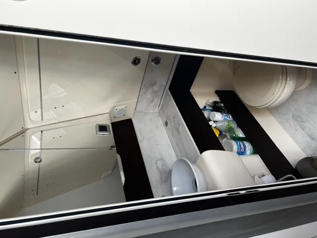 Island Waters Yacht Photos Pics 2018 Scout 380 LXF boat bathroom with sink, toilet, and cleaning supplies.