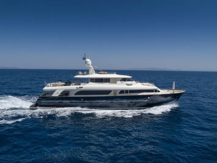 Hag Yacht Photos Pics Luxurious 2007 Custom Line Navetta 30 yacht cruising on open sea under clear blue sky.