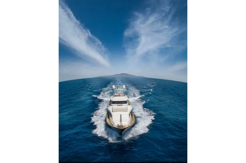 Hag Yacht Photos Pics Custom Line Navetta 30 yacht cruising on open sea under clear blue sky, 2007 model.