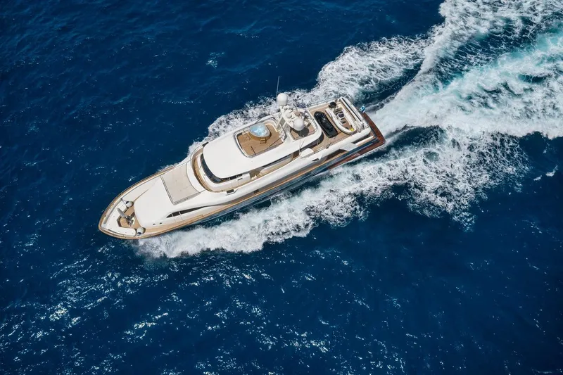 Hag Yacht Photos Pics Aerial view of 2007 Custom Line Navetta 30 yacht cruising in blue ocean waters.