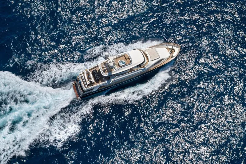 Hag Yacht Photos Pics Aerial view of 2007 Custom Line Navetta 30 yacht cruising on blue ocean waters.