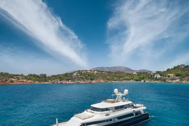 Hag Yacht Photos Pics Luxury yacht Custom Line Navetta 30, 2007, cruising in clear blue waters near a scenic coastline.