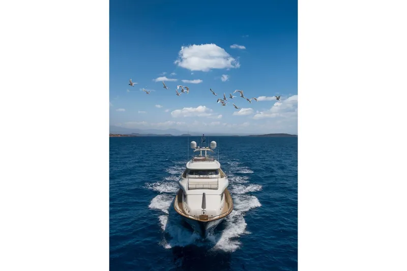 Hag Yacht Photos Pics Luxury yacht Custom Line Navetta 30 cruising under a clear blue sky with seagulls.