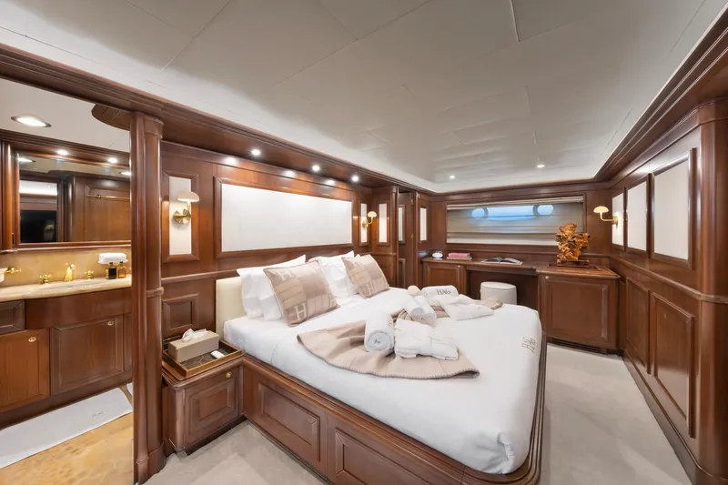 Hag Yacht Photos Pics Luxurious bedroom interior of 2007 Custom Line Navetta 30 yacht with elegant wood paneling.
