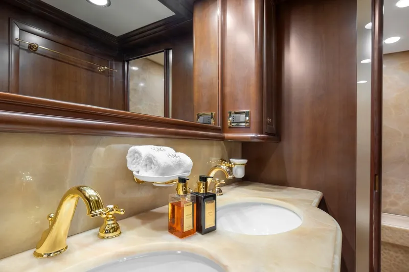 Hag Yacht Photos Pics Luxurious bathroom on Custom Line Navetta 30 yacht, featuring elegant fixtures and wooden cabinetry.