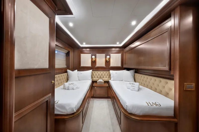 Hag Yacht Photos Pics Luxurious twin cabin interior on 2007 Custom Line Navetta 30 yacht, featuring elegant wood paneling.