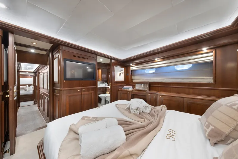Hag Yacht Photos Pics Luxurious bedroom interior on 2007 Custom Line Navetta 30 yacht, featuring elegant wood paneling.