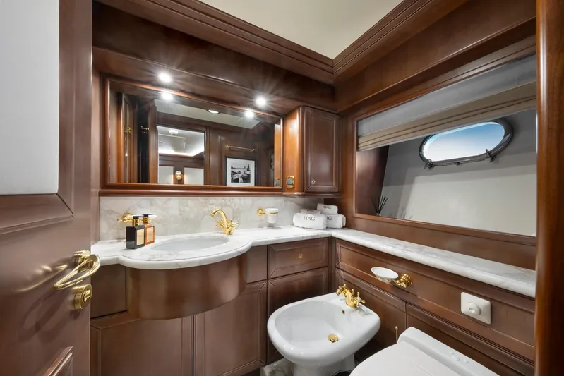 Hag Yacht Photos Pics Luxurious bathroom on 2007 Custom Line Navetta 30 yacht with elegant wood and marble finishes.